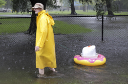 A man drags his belongings as he makes his way down the street in the Melrose Park neighborhood in Houston as Tropical Storm Harvey inches its way through the area on  Monday, Aug. 28, 2017. ( Elizabeth Conley / Houston Chronicle )